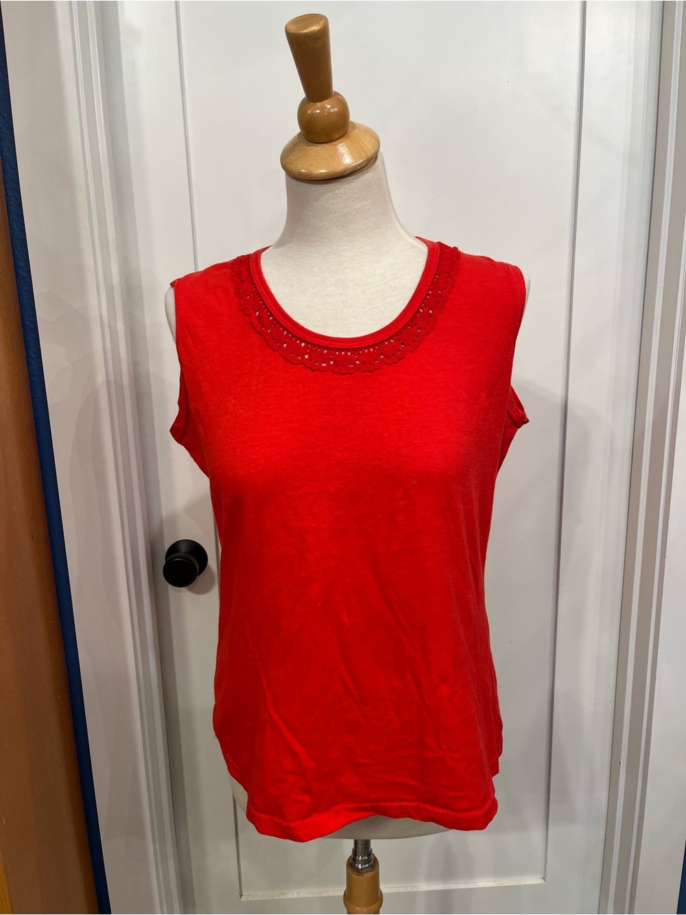 Sleeveless red-ish orange blouse with lace neckline